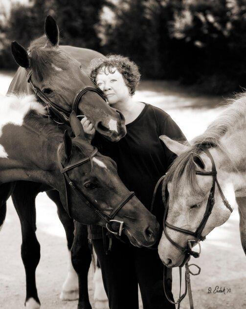 S.E Hinton posing with her horses.